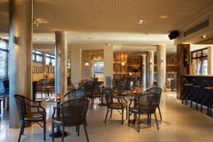 a dining room with chairs and tables in a restaurant at Luna Club Hotel Yoga & Spa 4Sup in Malgrat de Mar