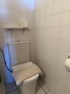 a bathroom with a white toilet with a towel at Luxury Beach House 2 in Xiropigado +15 photos