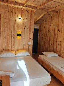 zwei Betten in einem Zimmer mit Holzwänden in der Unterkunft Ünal Boutique Hotel in Kemer + 45 Fotos
