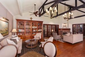 a living room with white furniture and a chandelier at Chimneys Nuwara Eliya in Nuwara Eliya