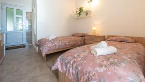 a bedroom with two beds with towels on them at Blue horizont in Mlini