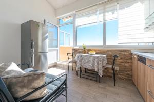 a kitchen with a table and chairs and a refrigerator at Blue horizont in Mlini