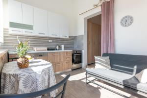 a kitchen and living room with a table and a couch at Blue horizont in Mlini