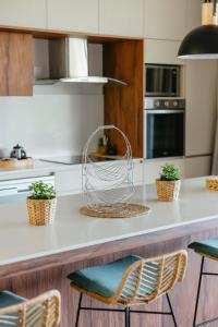 a kitchen with a counter with two chairs at Panoramic View Mauritius in Ruisseau Créole