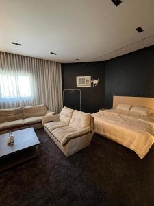 a large bedroom with a bed and a couch at Safety house in Tabuk
