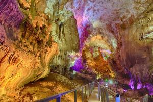 a tour of a cave with a staircase in it at Guest House Fazisi in Kutaisi