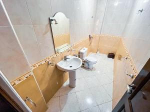 a bathroom with a sink and a toilet at Itrane Hostel in Tamraght Ouzdar