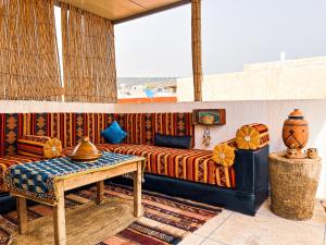 a living room with a couch and a table at Itrane Hostel in Tamraght Ouzdar