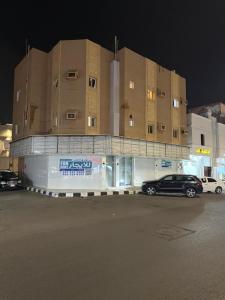 a car parked in front of a building at night at Safety house in Tabuk