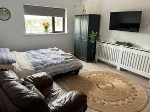 a living room with a couch and a table at The C & A Studio in Killala