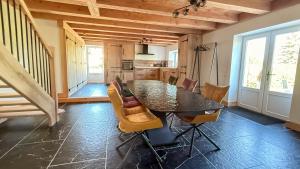 a dining room with a table and chairs at Domaine des Chênes in Saint-Pierre-les-Étieux