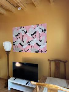a painting of white birds on a pink wall at Villa Dorée in Milan