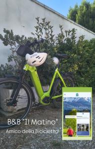 a bike with a face on it parked next to a bush at Il Matino in Leverano