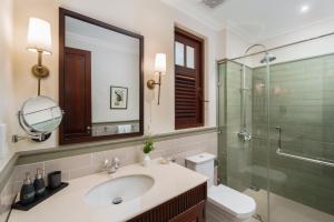 a bathroom with a sink and a glass shower at Chimneys Nuwara Eliya in Nuwara Eliya +70 photos