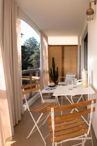 a dining room with a table and chairs on a balcony at MOB HOTEL Cannes in Cannes