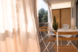 a room with a table and a white curtain at MOB HOTEL Cannes in Cannes +25 photos
