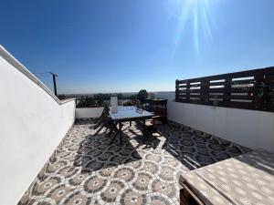 a patio with a table and bench on a balcony at ESTUDIO LAS PALMILLAS in Puebla del Río