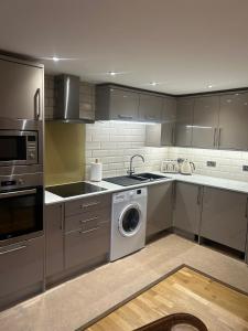 a kitchen with a washer and a dishwasher at A beautiful 2-bedroom Apartment in Skegness