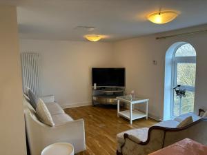 a living room with a couch and a tv at A beautiful 2-bedroom Apartment in Skegness