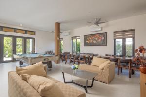 a living room with a pool table and chairs at Song Đan Villa in Sóc Sơn