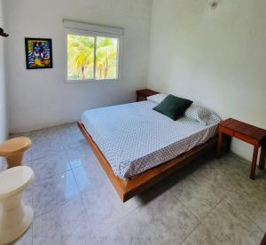 a bedroom with a bed and a window at Gaia - Casa de Playa in San Bernardo del Viento