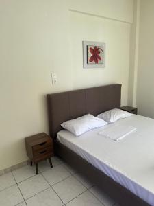 a bedroom with a large bed with a night stand at Luxury Beach House 2 in Xiropigado