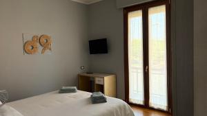 a bedroom with a bed and a large window at Suites Asia in Argelato