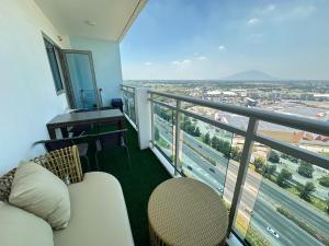 a balcony with a couch and a view of a city at 2 Bed Studio with Panoramic Sunrise View & BigBalcony in San Fernando