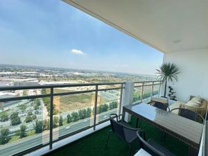 a balcony with a table and chairs and a view at 2 Bed Studio with Panoramic Sunrise View & BigBalcony in San Fernando