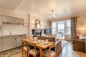 a kitchen and living room with a wooden table in a room at 2 Bed in Woolacombe oc-dolph in Woolacombe