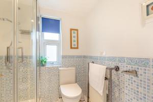 a bathroom with a toilet and a glass shower at 2 Bed in Woolacombe oc-dolph in Woolacombe +14 photos