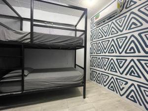 a room with two bunk beds against a wall at OyeBonita Hostel in Panama City