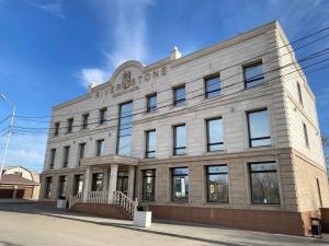 a large brick building on a city street at River Stone in Pavlodar