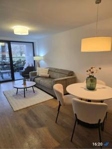 a living room with a couch and a table at 365 apartmány LINEA in Piešťany