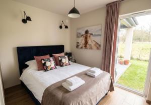 a bedroom with a bed with two towels on it at Domki La Bella 1 in Aleksandria