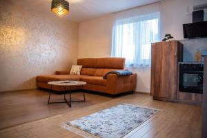 a living room with a couch and a table at La Palma Gúta in Kolárovo