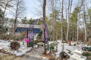 a garden with an arch in the snow at 3 Mi to Bath Historic District! Stylish Studio in Harding