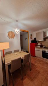 a kitchen with a wooden table and chairs in a room at Il Cuore del Tonale in Passo del Tonale