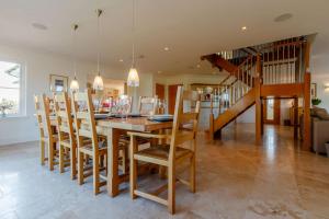 a dining room with a wooden table and chairs at Taigh Gleusta in Angus