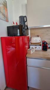 a red refrigerator in a kitchen next to a counter at Il Cuore del Tonale in Passo del Tonale