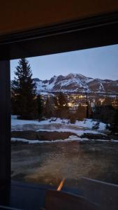 a window with a view of a snow covered mountain at Il Cuore del Tonale in Passo del Tonale