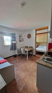 a kitchen and dining room with a table and a kitchen and a room at Il Cuore del Tonale in Passo del Tonale +44 photos