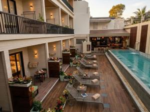 an apartment patio with a swimming pool and tables at Simple Life Resort Koh Tao in Ko Tao