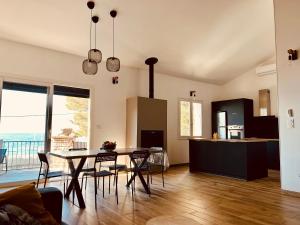 a kitchen and dining room with a table and chairs at Duplex face à la mer in Saint-Florent +11 photos