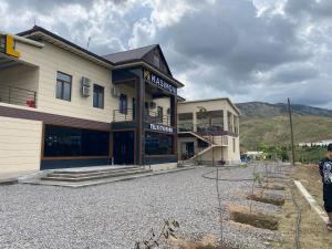 a man standing in front of a building at Hotel KASIMOV in Podan