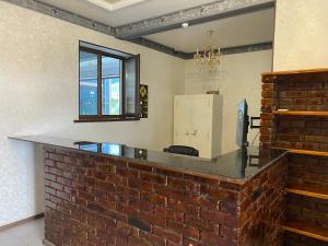 a brick bar in a room with a brick wall at Hotel KASIMOV in Podan