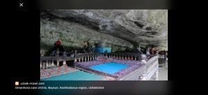 a group of people standing in a cave at Hotel KASIMOV in Podan