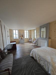 a bedroom with a bed and a living room at B&B Le MONSEG 33 in Monségur