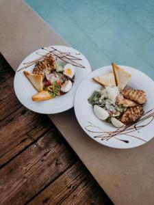 two plates of food on top of a table at Гук готельно-ресторанний комплекс in Bukovel