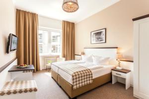 a hotel room with a bed and a window at Hotel Strandschlösschen in Travemünde +38 photos